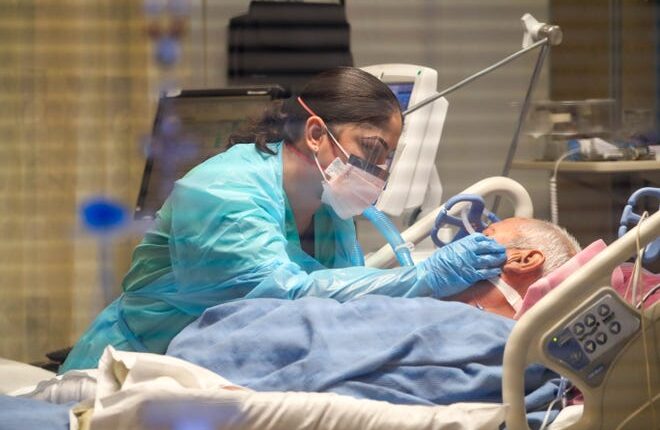 Jose Garcia, 68, who has been sedated and intubated for COVID-19 since November 13, will be visited on Monday November 30, 2020 in Las Cruces by his daughter Carolina Garcia, a nurse at the Memorial Medical Center.  Carolina says she is wiping away tears that form after whispering in his ear.