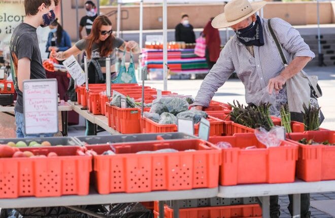 Shoppers will pick up goods at the Farmers Market in downtown Las Cruces on Saturday, April 11, 2020.