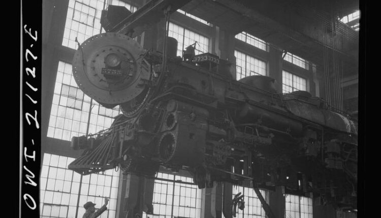 A steam engine is lifted at the Albuquerque Locomotive Repair Shops in 1943.