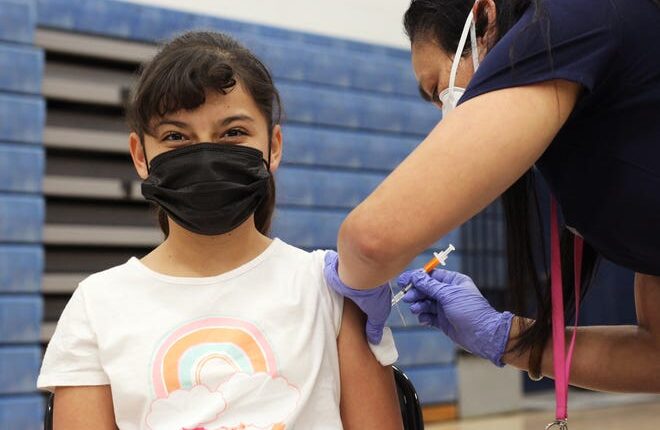 Alexa Corrales, 10, winced when she received her first dose of the COVID-19 vaccine for children ages 5-11 at Vista Middle School on Thursday, November 18, 2021.