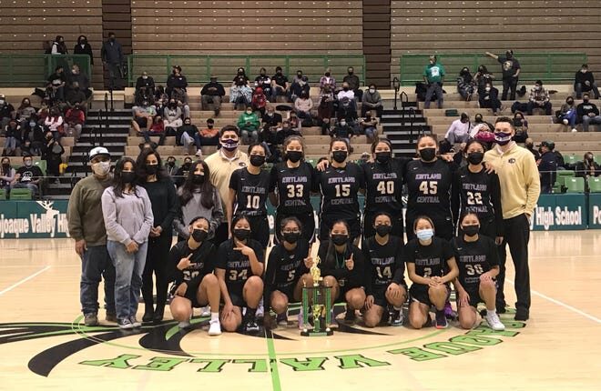 The Kirtland Central girls' basketball team poses for photos after winning the championship in their division of the Ben Lujan Invitational at Pojoaque Valley High School on Saturday, December 18, 2021.