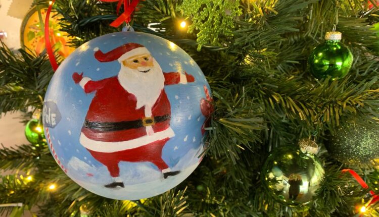 A Santa ornament at the Mas Art Gallery welcomes the holiday with joy and open arms.