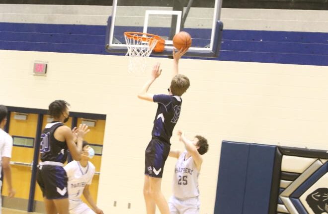 La Cueva High School sophomore Daniel Jacobsen puts on a slight lay against Piedra Vista's Douglas Pendergrass (25) during a game at the Jerry A. Conner Fieldhouse on Saturday, Jan. 22, 2022.