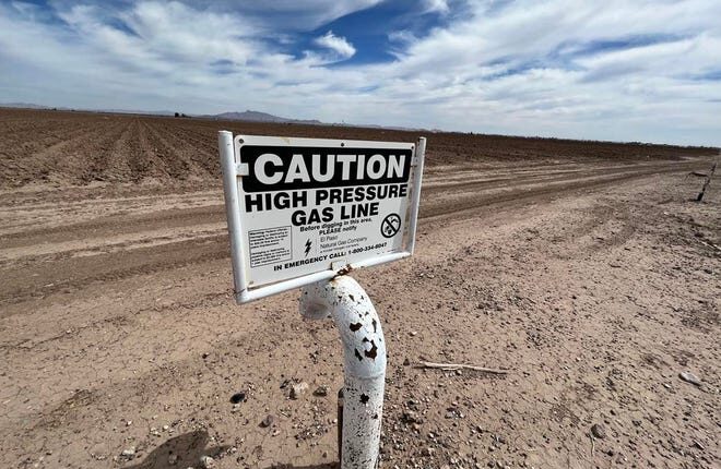 A notice of an El Paso Natural Gas/Kinder Morgan gas line is seen adjacent to a farm in Luna County, NM on Tuesday, April 19, 2022.