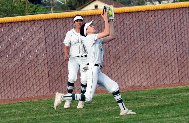 Mayfield's Rauni Gallegos makes the catch in left center field as her teammate Jayden Ybarra backs her up as Mayfield took on Organ Mountain at Field of Dreams softball complex on Tuesday night.