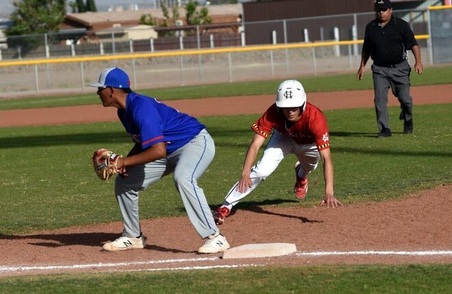 Bulldawg First Baseman Juan Perez waits for the throw from the catcher as Centennial's Eli Martinez dives back to first base.  Photo taken 4/22/22.