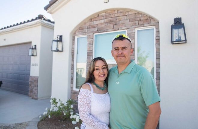 Tammy Hicks and Jake Glossop smile in front of their new house in Las Cruces on Friday, April 29, 2022. The couple and their home was featured on an episode of the TV show 