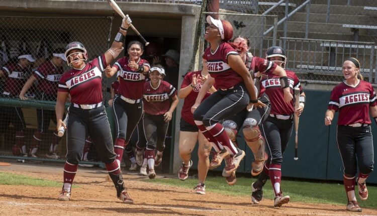 The New Mexico State University softball team celebrates its win in the first round of the WAC tournament May 11.