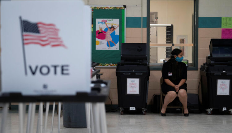 Machine judge Valerie Del Plain waits by the ballot box at Mesilla Elementary School during the New Mexico primary in Mesi...