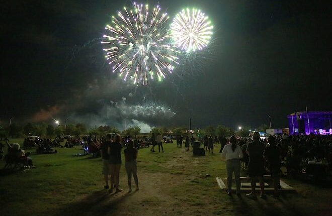 Fireworks illuminate the crowd at Pat and Lou Sisbarro Community Park on the New Mexico State University campus during the Fourth of July Concert on July 4, 2021.