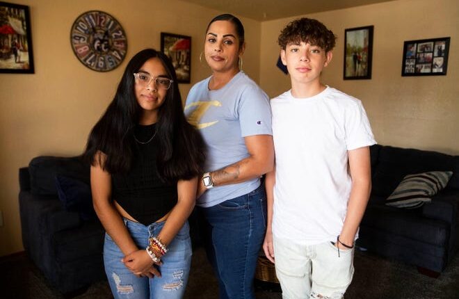Natalie Medina, center, and her children, Marina and Mariano Medina, pose for a portrait in their home on Saturday, July 30, 2022. Medina was recently approved for a rental assistance voucher, but is struggling to find approved housing in Las Cruces.
