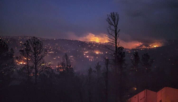 Fire burns along a hillside in the Village of Ruidoso, N.M., on Wednesday, April 13, 2022. Officials say a wildfire has burned about 150 structures, including homes, in the New Mexico town of Ruidoso. (Alexander Meditz via AP)