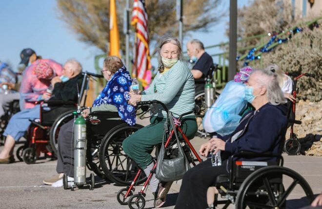 Patients at the Haciendas at Grace Village assisted living facility in Las Cruces are treated to a law enforcement car parade on Tuesday, Dec.  8, 2020.