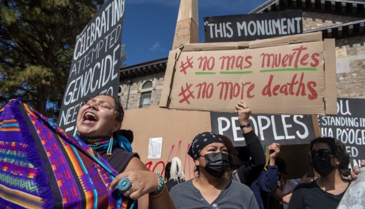 Protesters in Santa Fe march, throw paint on monument