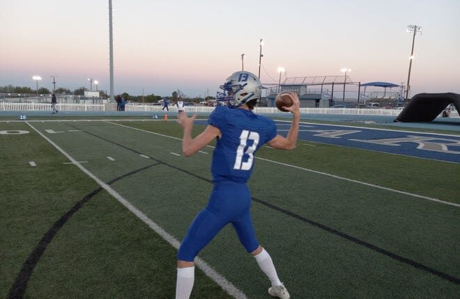 Carlsbad High School senior quarterback Dane Naylor warms up before the Oct.  28, 2022 game versus Hobbs at Carlsbad.  The Eagles won 42-7.