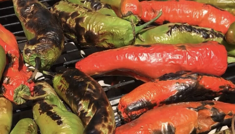 Red and green chiles roasting on a grill