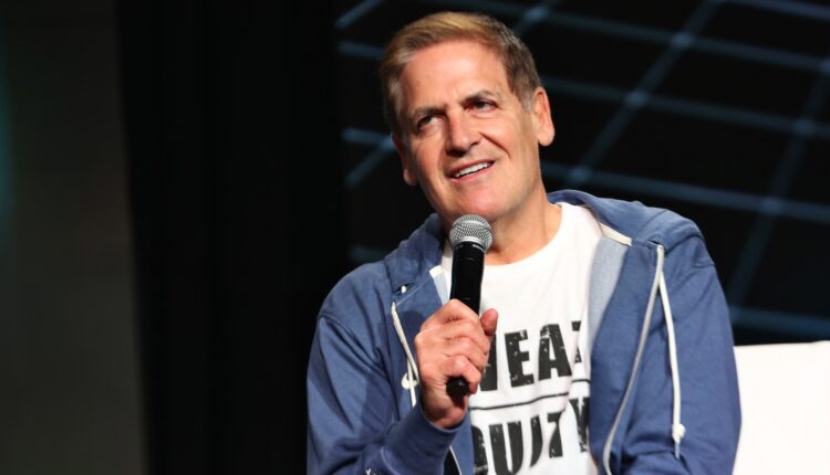 A photo shows Mark Cuban speaking into a microphone at a tech conference.