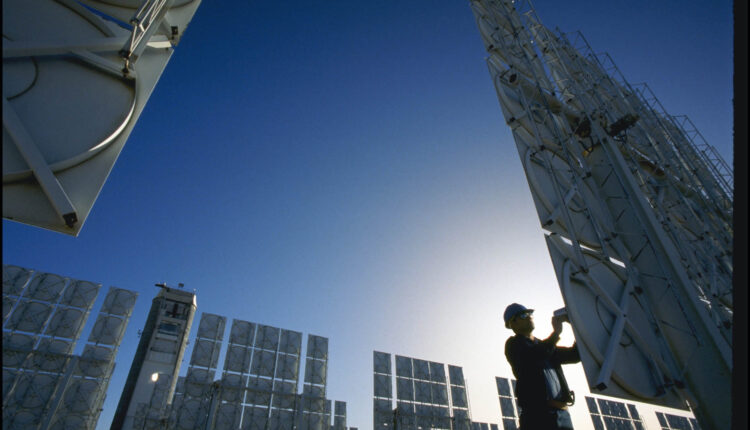 A technician servicing photovoltaic cells at a solar energy farm In Albuquerque. (Photo By Getty Images)