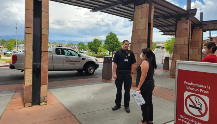 They were handing out free masks outside an Albuquerque hospital. Then security stepped in. 
