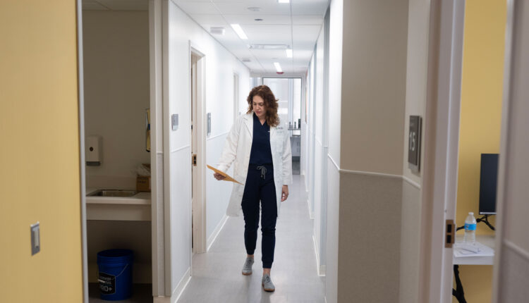 A photo of a doctor walking down a hallway.