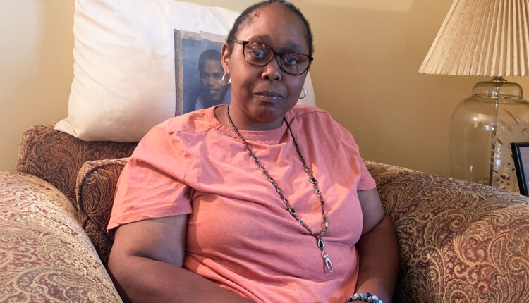 A photo of a woman sitting in a chair indoors.