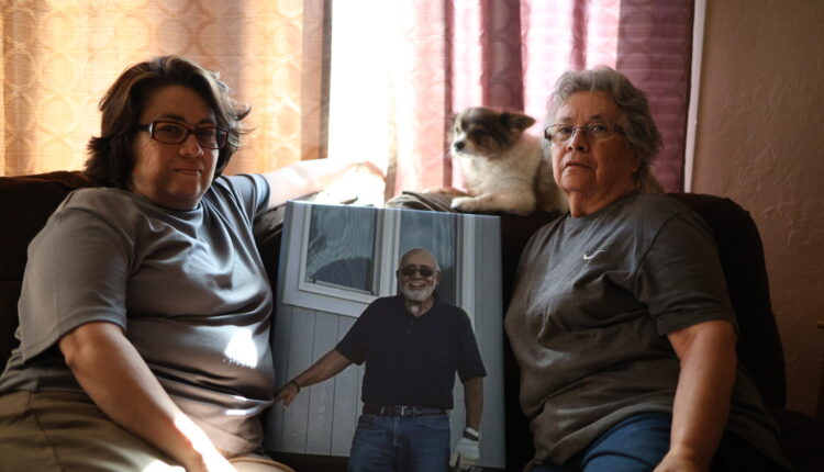 Maria Luisa Sena and her daughter, Nicole Sandoval, sit with a photo of Donato "Frank" Sena in the home the Senas have lived in since the Hermits Peak-Calf Canyon Fire last spring