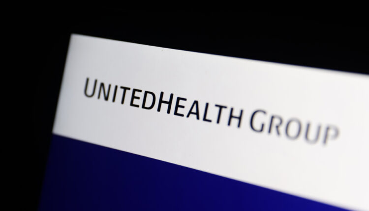 A photo of a laptop screen showing UnitedHealth Group's logo.
