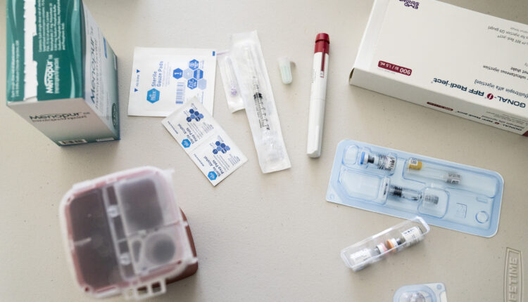 In vitro fertilization medications and sanitary products are displayed on a countertop.